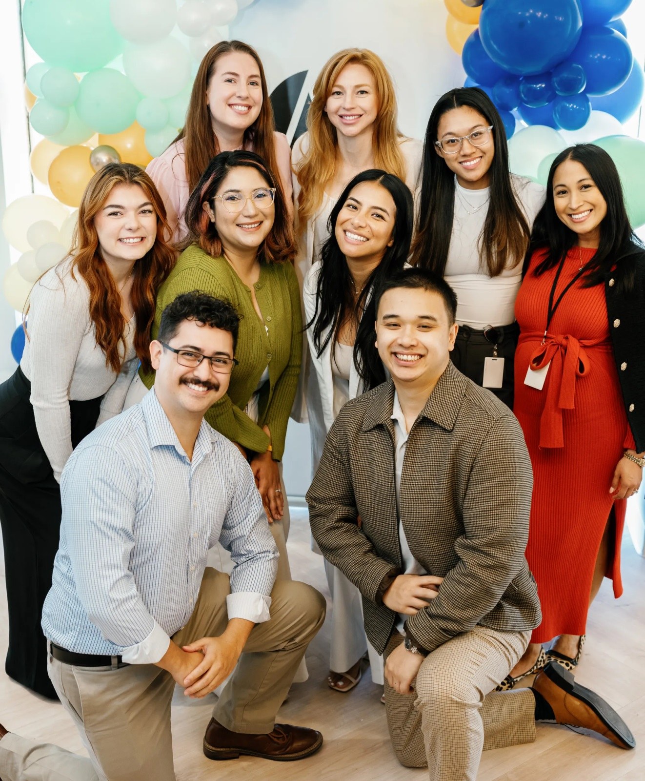 Seven women and two men smiling.